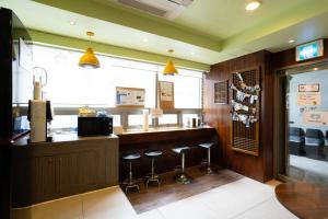 a bar in a restaurant with stools at a counter at K Stay Guesthouse Myeongdong first in Seoul