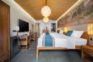 a bedroom with a large bed and a tv at Yangzhou One or Two Mountain B&B in Yangzhou