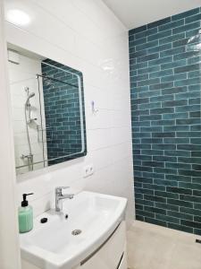 a bathroom with a sink and a mirror at Шикарні апартаменти м Мінська 10 хв пішки, 3 поверх, Богатирська 6А in Kyiv