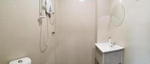 a white bathroom with a shower and a sink at Rock & Roll Hotel Klang in Klang +91 photos