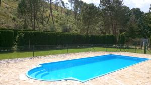 a blue swimming pool in the middle of a yard at Casa Rural Mi Camino in Riópar