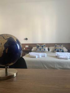 a room with two beds and a globe on a table at Dimora del Salento Apartment in Brindisi