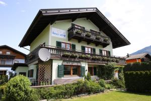 a house with green shutters and a balcony at Haus Vera in Zell am See