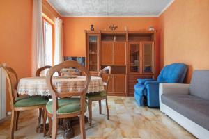 a living room with a table and a couch at Comfort a 5 Minuti Dal Mare in Camogli +23 photos