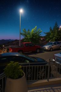 a parking lot at night with cars and a street light at SamolisApartment in Anogeia +9 photos