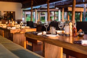 a table in a restaurant with wine glasses on it at Qunci Villas Resort in Senggigi