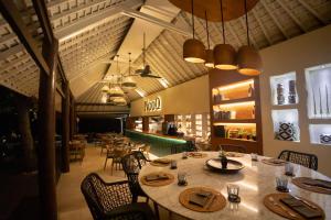 a dining room with a table and chairs and a restaurant at Qunci Villas Resort in Senggigi