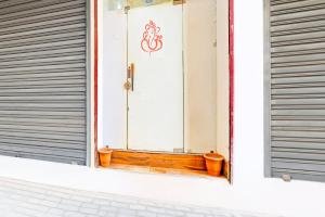 a window with a door with a sign on it at Super Hotel O Sector 45 Formerly Manyavar in Chandīgarh