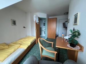 a small hotel room with a bed and a table at Aparthotel Mariazellerhof in Sankt Pölten