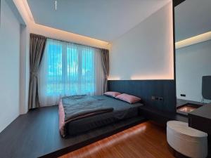 a bedroom with a bed and a large window at Sri Indah Premium in Sandakan