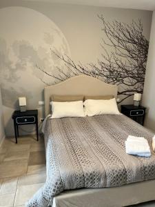 a bedroom with a large bed with two night stands at Tenuta Serena Apartments in Molfetta