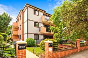 an apartment building with a sign in front of it at Burwood 2Br Apt Near Chiantown Shopping Center in Sydney