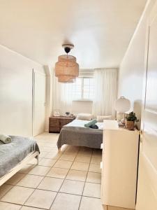a bedroom with a bed and a table with a lamp at The City Centre Apartment Turku in Turku