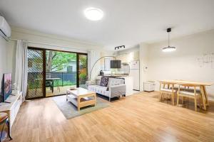 a living room with a couch and a table at Burwood 2Br Apt Near Chiantown Shopping Center in Sydney
