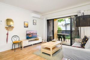 a living room with a couch and a table at Burwood 2Br Apt Near Chiantown Shopping Center in Sydney