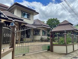a fence in front of a house at Yoga Bed and Breakfast in Chiang Mai