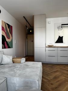 a living room with a bed and a cabinet at Japandi Apartment Pogórze in Pogórze
