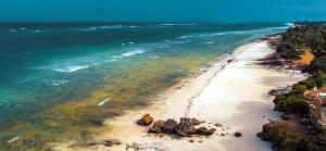 an aerial view of a beach with rocks and the ocean at Casa Nampala Diani 1 Bedroom Jungle in Diani Beach