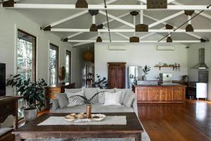 a living room with a couch and a table at The Boathouses at Leaves & Fishes in Lovedale