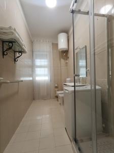 a bathroom with a shower and a sink and a toilet at Marinella House in Siracusa +23 photos