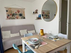 a living room with a table and a couch at Repli des 3 ponts in Saint-Jory