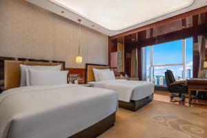 Katil atau katil-katil dalam bilik di Chengdu CYNN Hotel
