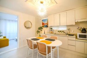 a kitchen with a table and chairs in a room at Ongi House in Seoul