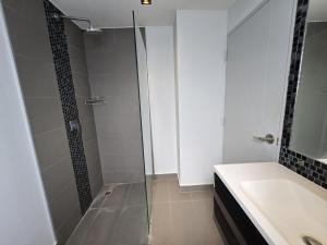 a bathroom with a glass shower and a sink at Sleek Corner 1 Bed Apt T1-607 in Chalong  +8 photos