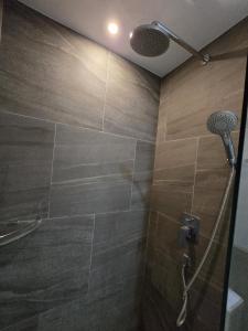 un baño con ducha con cabezal de ducha en Blue Edge Studio T3-527, en Ban Klang