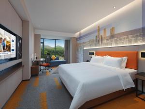 Postel nebo postele na pokoji v ubytování Hampton by Hilton Dongguan Fenggang