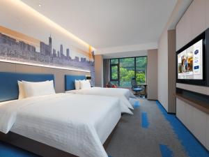 Postel nebo postele na pokoji v ubytování Hampton by Hilton Dongguan Fenggang