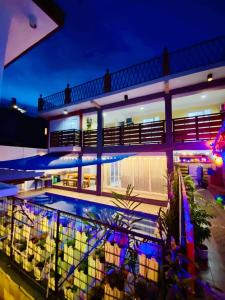 a house with a swimming pool at night at Mansion Mexicana Private Resort in Calamba