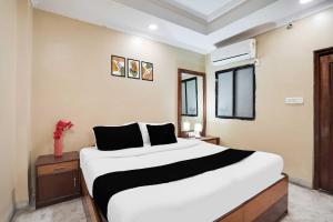 a bedroom with a large white bed in a room at Collection O Pithampur in Indore