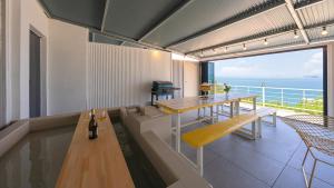 a room with a table and a view of the ocean at Yeosu Clermonde Pool Villa N Jacuzzi in Yeosu