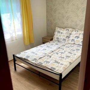 a bed in a small room with at Apartmanház - Delta Kemping in Balatonederics