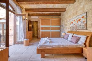 a bedroom with a large bed in a room at New to the market - Unique house with pool by SF Homes in Għargħur +46 photos