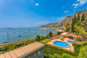 a view of a body of water with boats at Giulia's Apartment on the sea in Taormina