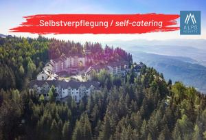 a resort on top of a mountain with trees at Bergresort Gerlitzen by ALPS RESORTS in Treffen