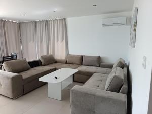 a living room with a couch and a table at Victoria in Byala