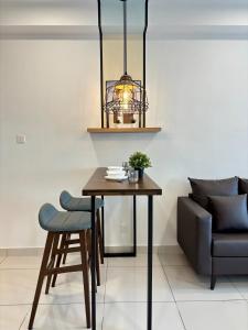 a dining room with a table and a chair at KSL Modern Studio 1-2Pax #Daya#Austin#Ikea#Aeon in Johor Bahru