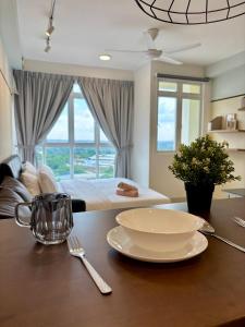 a table with a bowl and a plate on a table at KSL Modern Studio 1-2Pax #Daya#Austin#Ikea#Aeon in Johor Bahru +12 photos