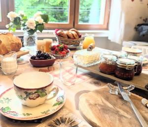 a table topped with a cup and plates of food at Chambres d'hotes la forêt in Longwy