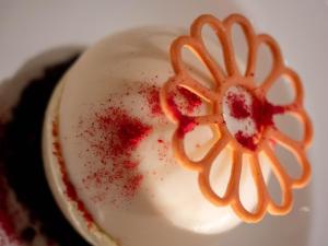a close up of a cupcake with sauce on it at Kaitahi Lodge in Palmerston North