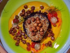 a green plate of food with nuts in the shape of a heart at Kaitahi Lodge in Palmerston North