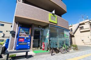 a store with a bike parked outside of it at Green Guesthouse in Kagoshima
