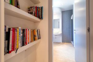 a hallway with shelves filled with books at Casa Katy Sul Porto Di Stintino in Stintino
