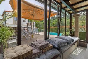 a patio with a couch and an umbrella at Quinta Da Cevidade in Melgaço