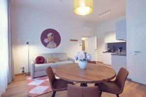 a living room with a table and a couch at LeonArt Living 21 in Graz