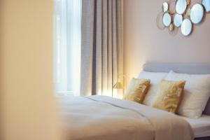 a bedroom with a bed with pillows and a window at LeonArt Living 21 in Graz