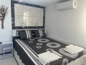 a bedroom with a bed with black and white sheets at Countryside Retreat 3 in Agios Arsenios